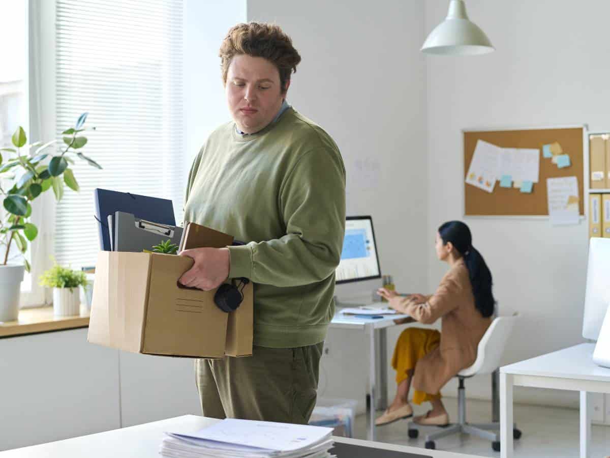 Man packing his things after being laid off