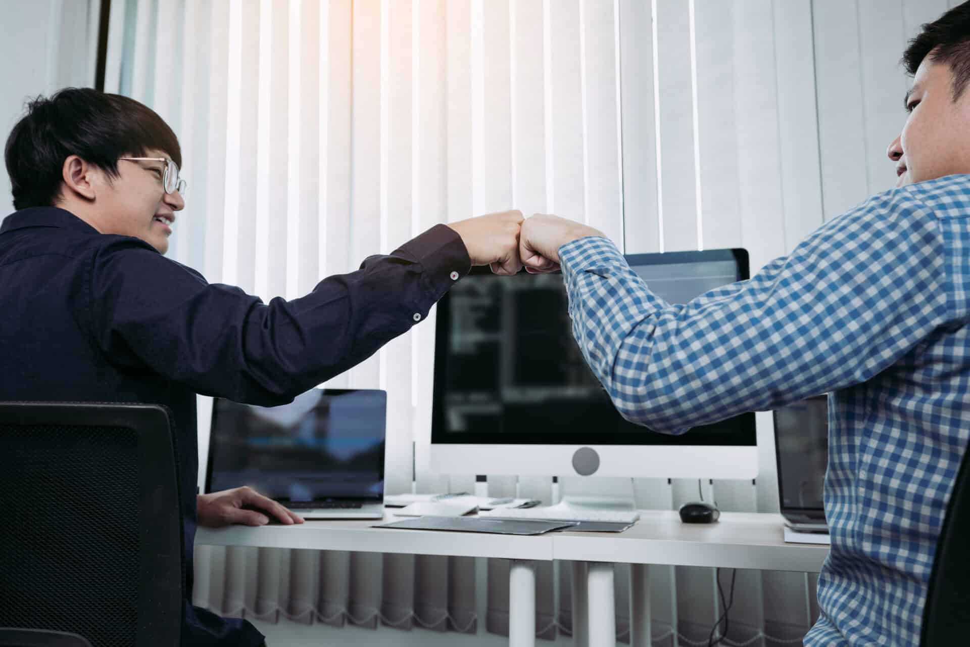 asian employee software developers celebrate success project by