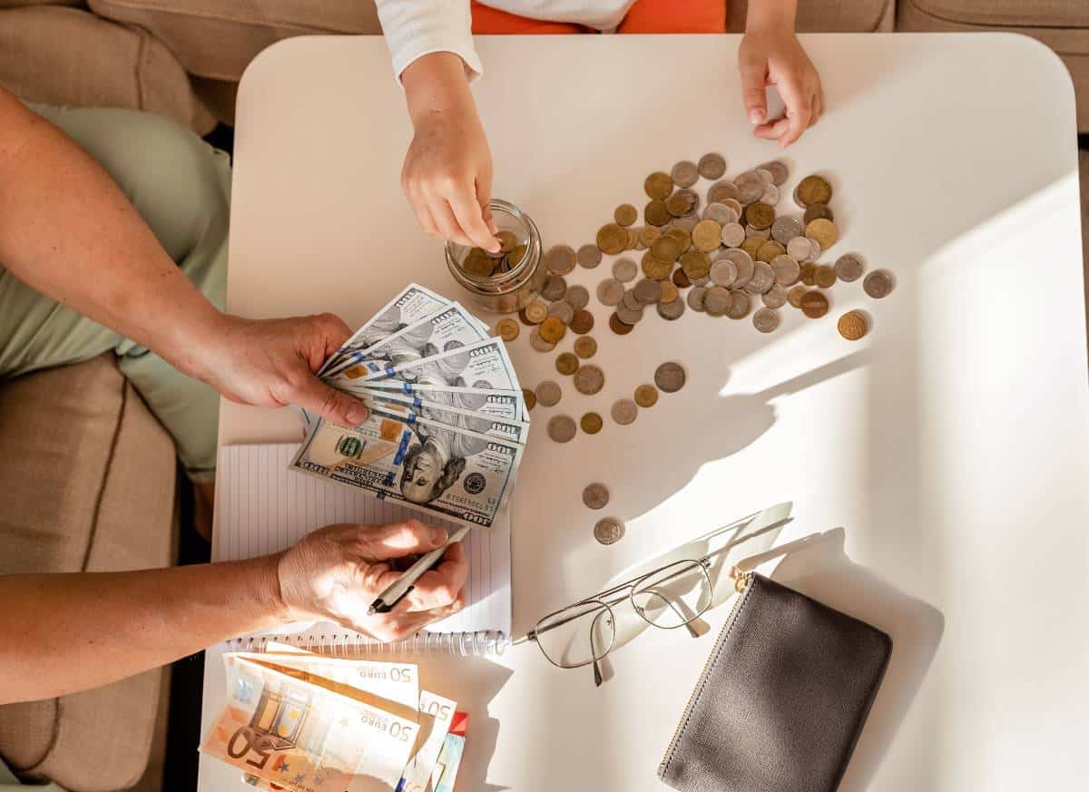 Pictyre of coins and money with people counting it