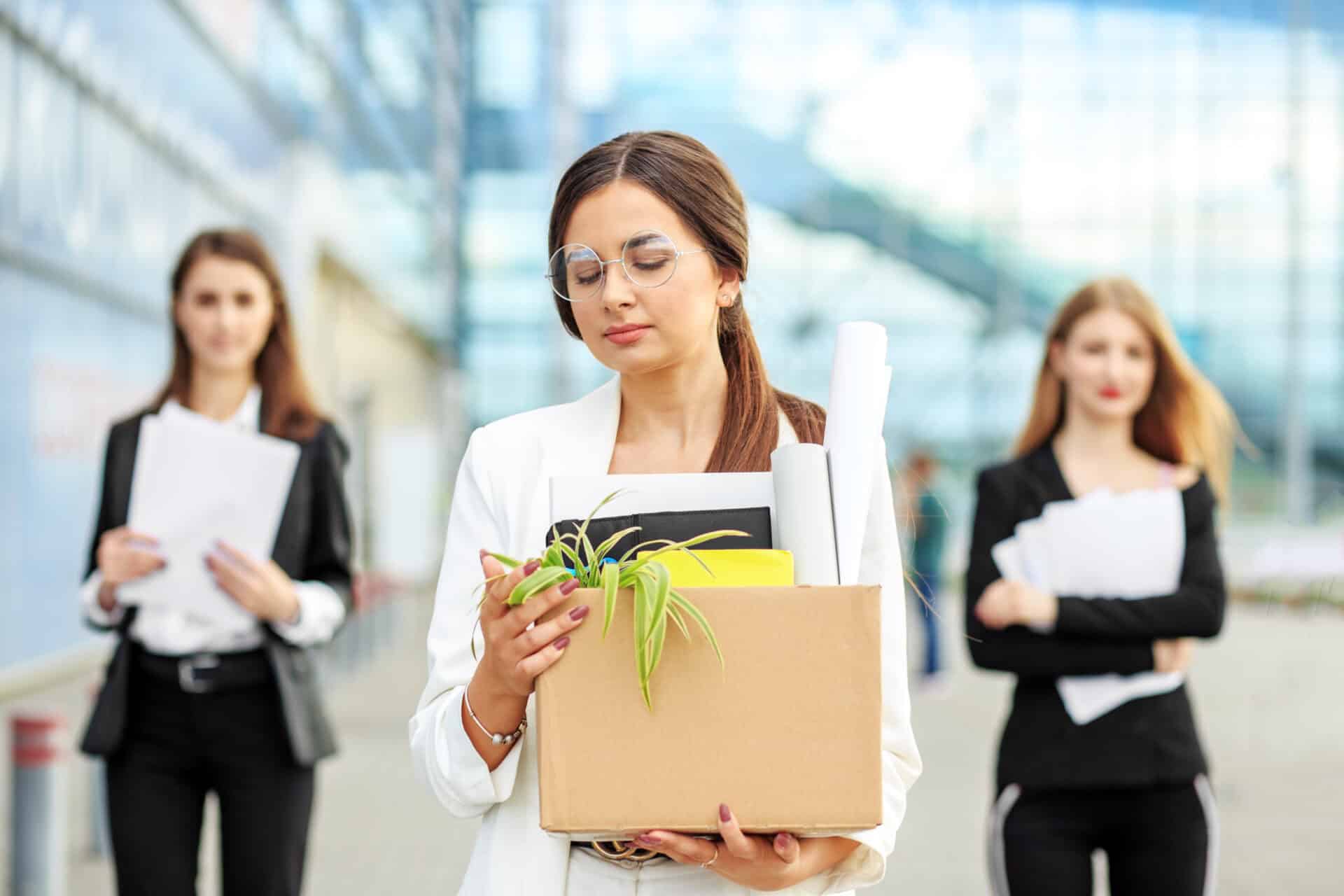 A young beautiful woman was fired from her job. The end of a career. Concept for business, unemployment, labor exchange and dismissal.