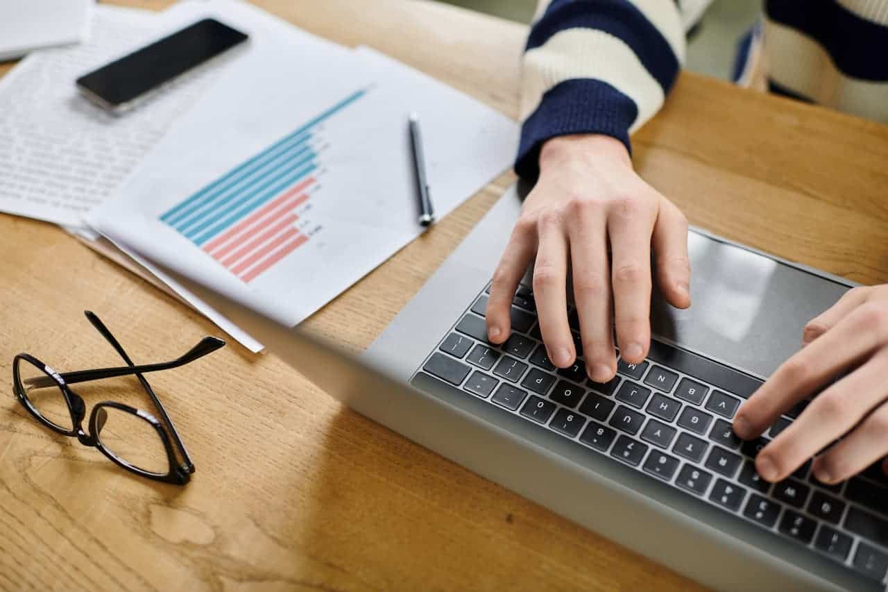 Hands of someone working on their laptop doing financial planning