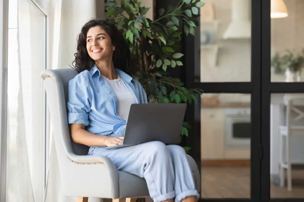 happy millennial woman sitting