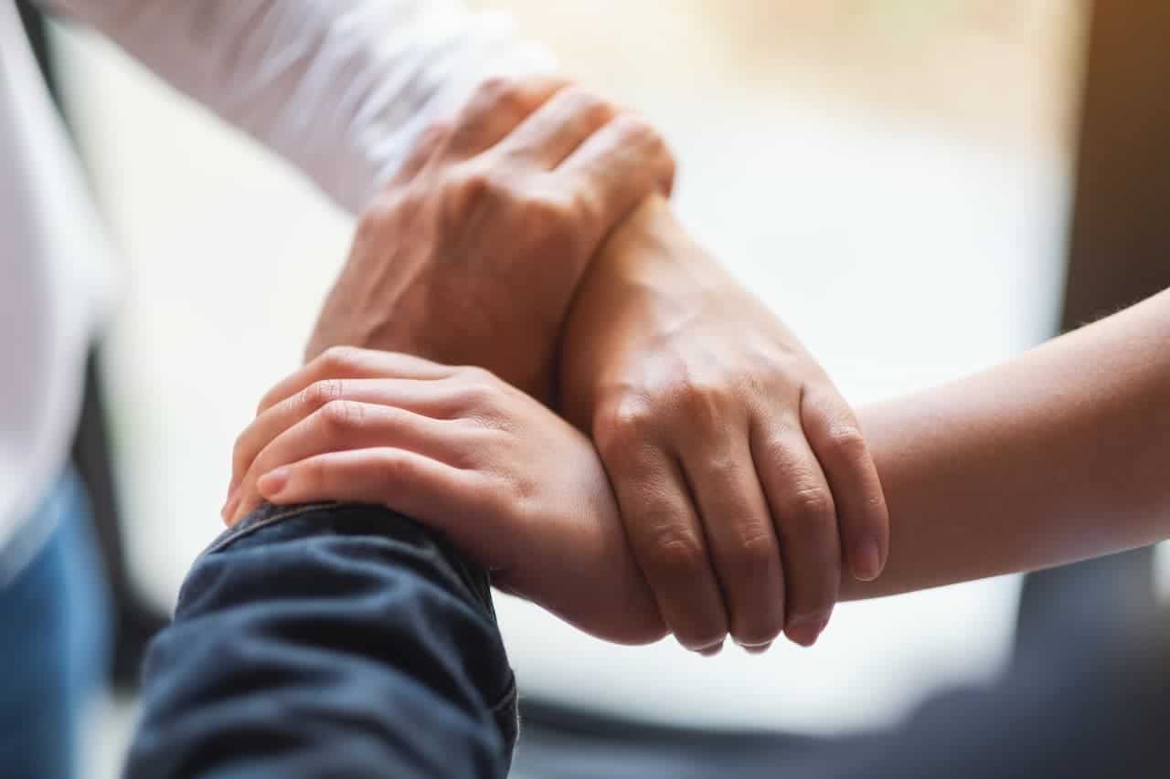 Hands of 3 people