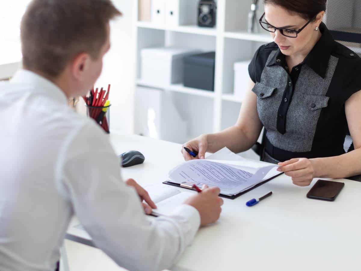 insurance license career change ll, woman and man discussing documents