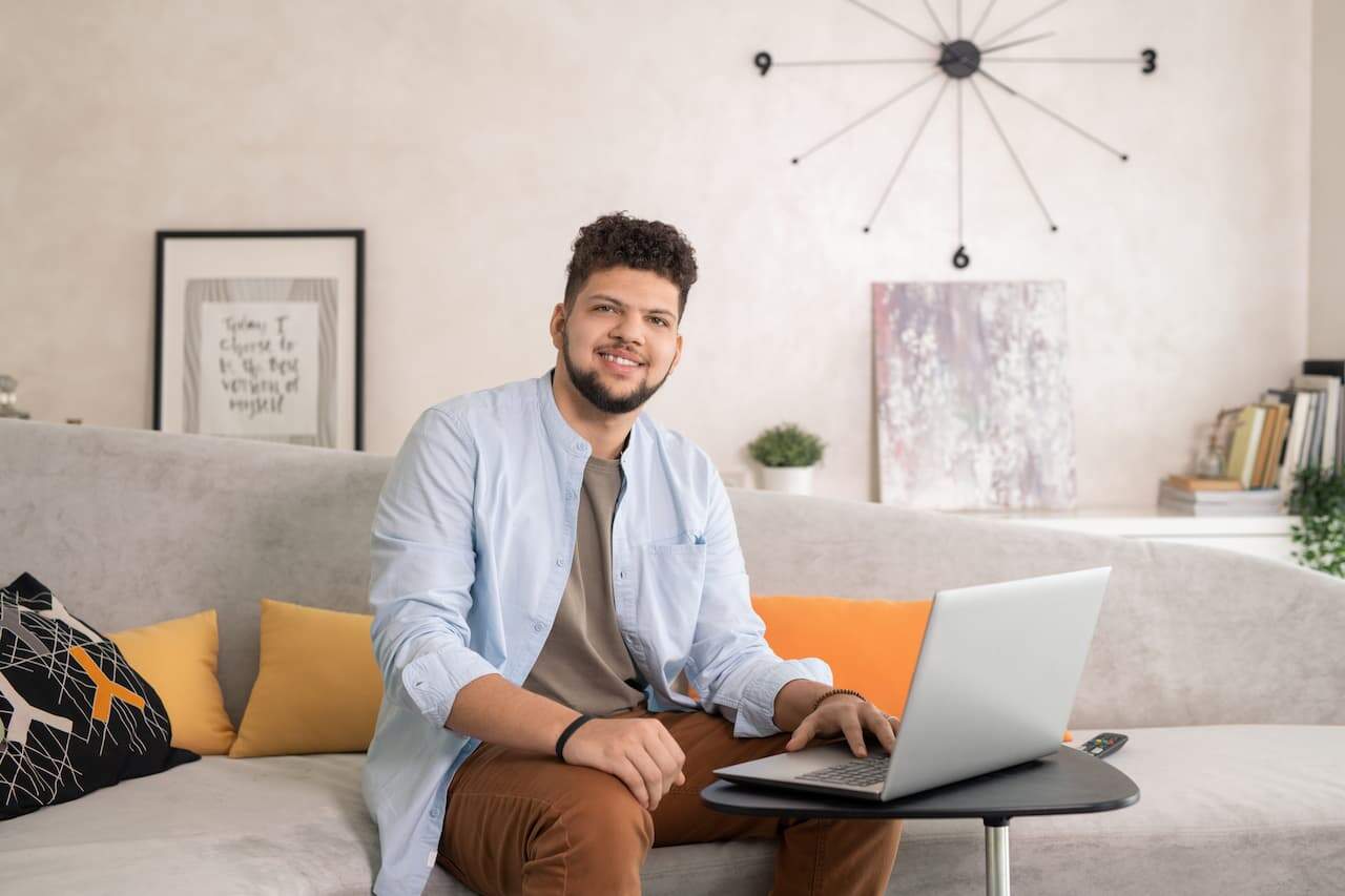 Young man using laptop while working in home office