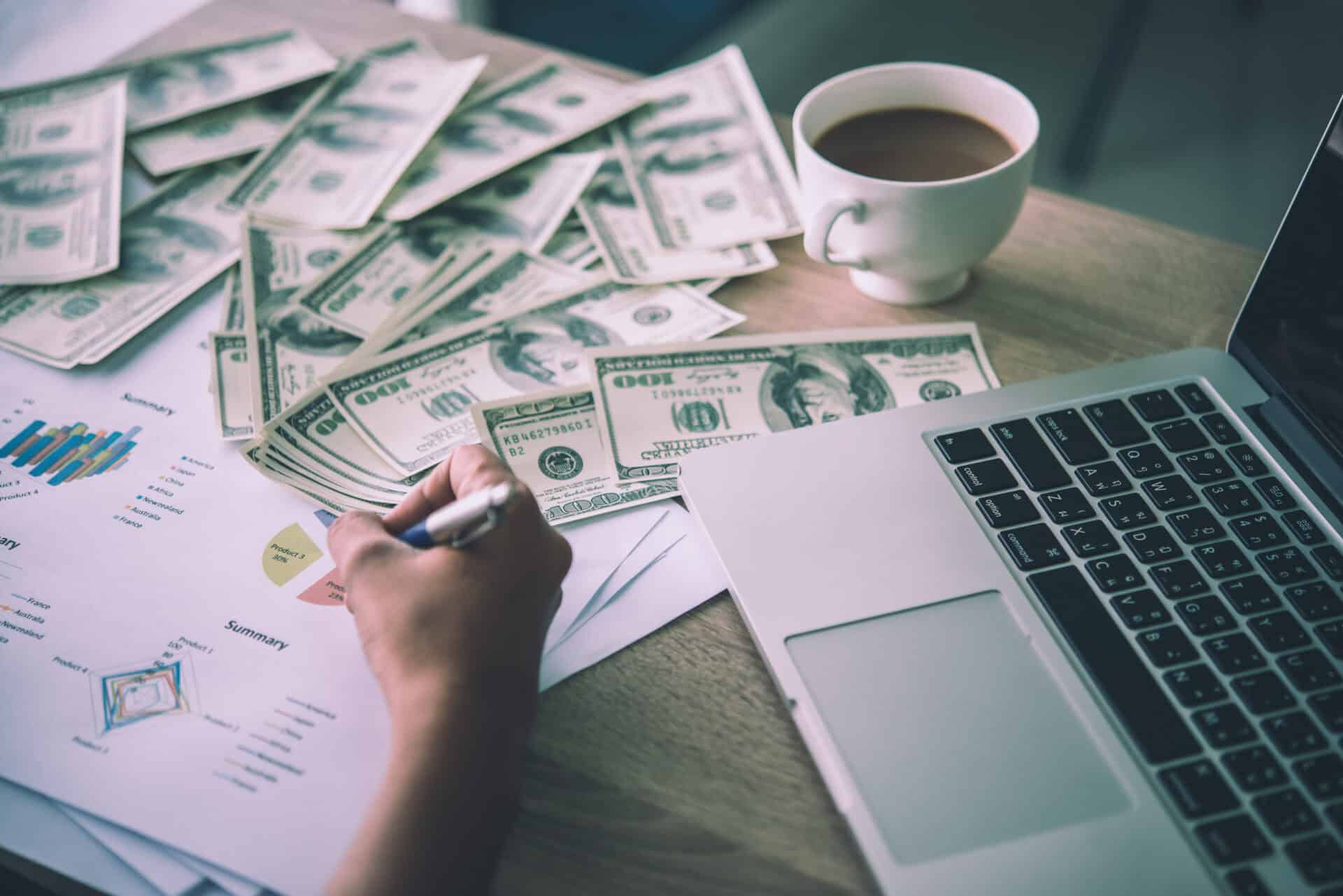 working place of trader. the table covered by cash notes, keyboa